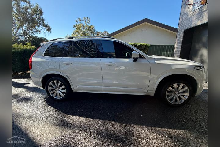 Modern performance SUV with precision-tinted windows on a coastal road